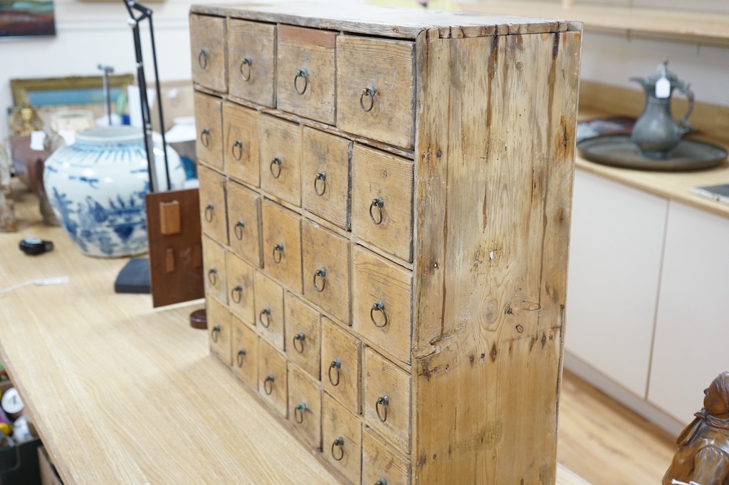 A Victorian stripped pine spice cabinet of twenty six drawers, 68cm wide x 63cm high x 22cm deep. Condition - fair to good